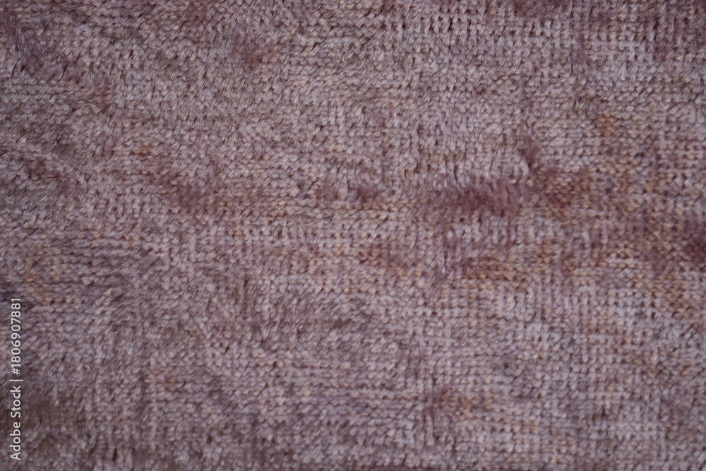 Fototapeta premium Dusty rose velour fabric texture, close-up macro view of dusty rose velour fabric showing its soft, plush surface and fine fibers. The detailed texture highlights the smooth, slightly fuzzy appearanc