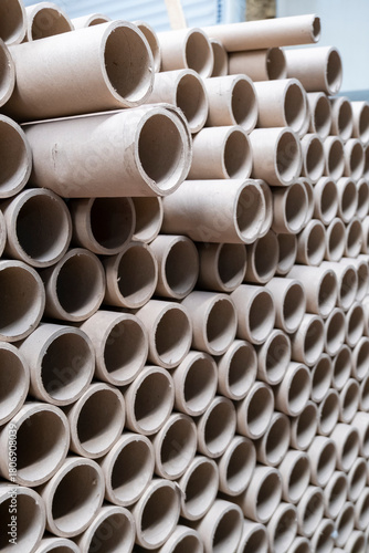 Close up view of stack of cylindrical cardboard tubes.