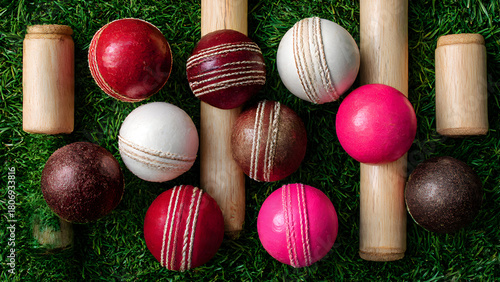Overhead shot of cricket scorebook open beside boundary rope on grass, pen and scorer's accessories visible