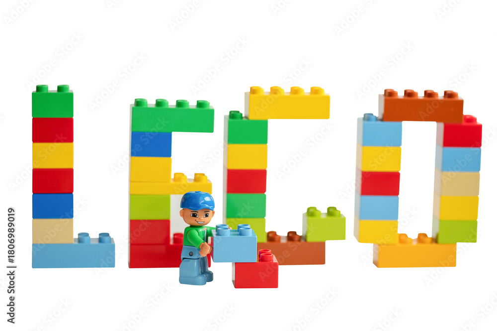 Naklejka premium A Lego minifigure with toy bricks in front of the word 