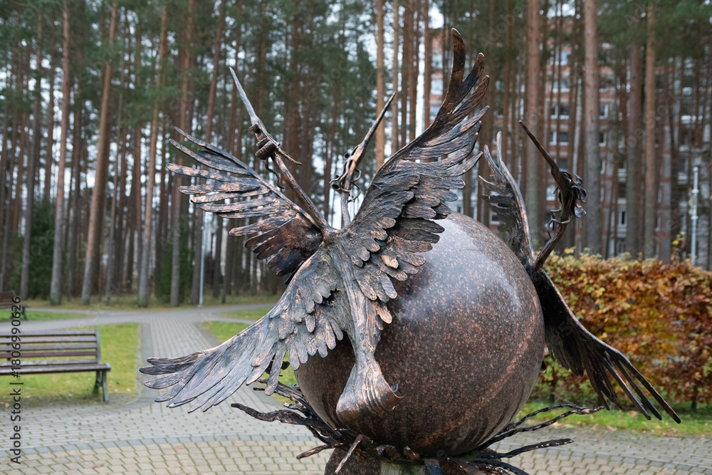 Obraz premium Bronze sculpture of Cranes on a Globe, the symbol from the Visaginas Coat of Arms, Lithuania