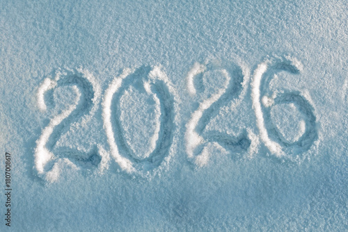 Inscription 2026 on real white snow as symbol of coming Christmas and New Year