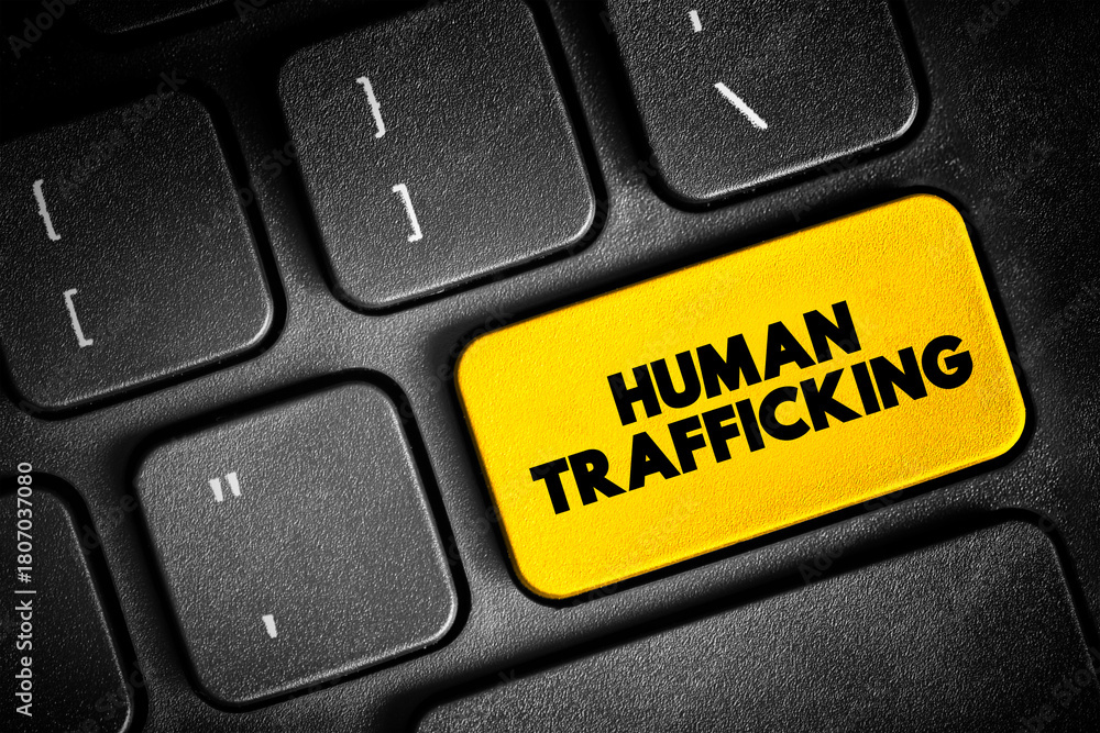 Fototapeta premium Human Trafficking is the trade of humans for the purpose of forced labour, text button on keyboard, concept background