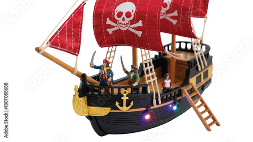 A detailed toy pirate ship model with red sails featuring white skull and crossbones symbols 
