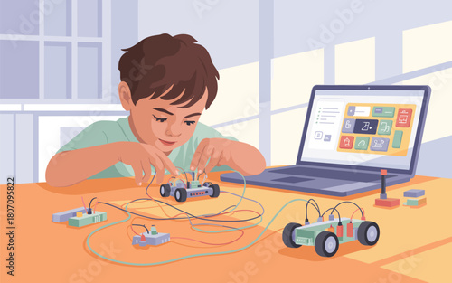 Young boy learning programming by building and controlling robots with a laptop