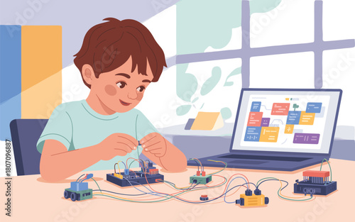 Young boy engaged in STEM education with electronics and coding on laptop