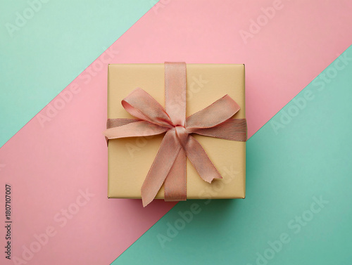 Beautiful Gift Box with Bow on Stylish Pink and Green Background