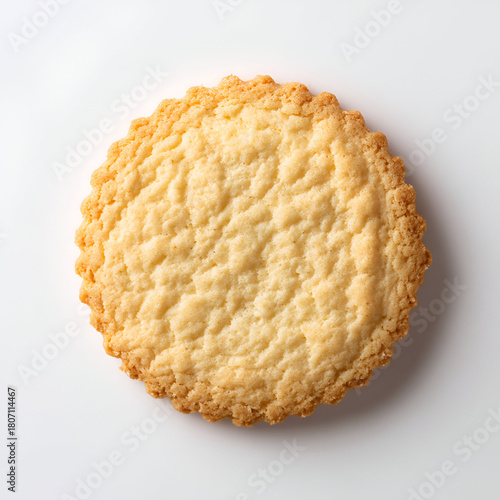 Golden cookie shows crispy texture on white.  Studio shot and natural light for product photography and food blog.