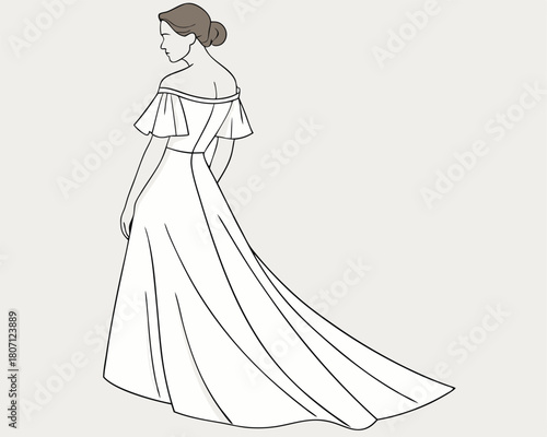 Elegant bride in a modern wedding gown from the back view with flowing train and bun hairstyle.