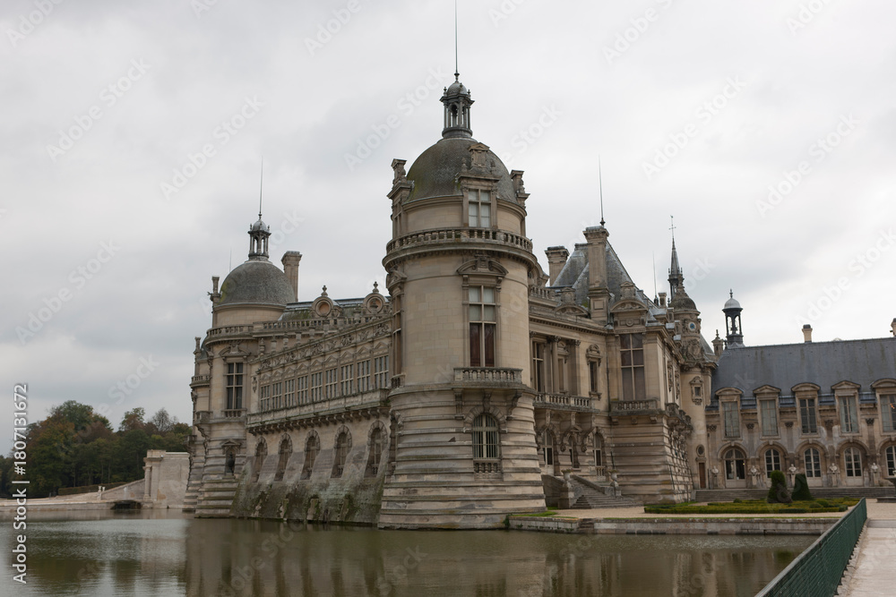 Obraz premium France's Chantilly Castle on a cloudy summer day