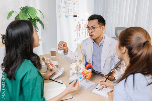 Group of doctors and nurses consulting about a complex patient case in hospital office. Team analyzing medical data and discussing diagnostic plans for accurate and efficient treatment.