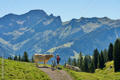 woman riding her electric mountain bike in the Bregenz Forest Mountains near near village of Au, Vorarlberg, Austria
