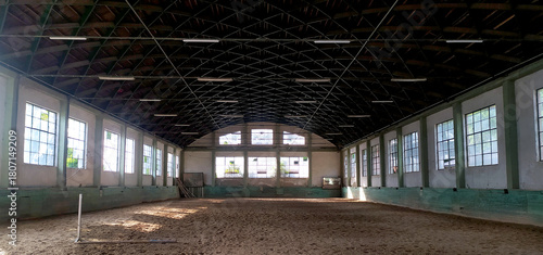 Covered arena building interior without people ready for equestrian training. Place to train horses