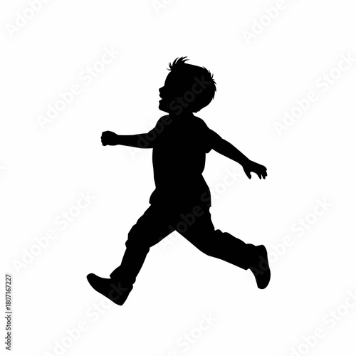 Silhouette of a young boy running and jumping with joy in the air.