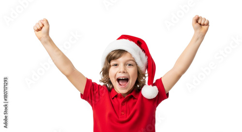 Excited young boy wearing a santa hat and red shirt, with arms raised in celebration