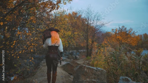 Beauty woman captain pirate holds in hands old style brown chest walking at island beach sea back rear view, armed with pistol gun. Girl thief steampunk costume. game search for pirates treasure 4k