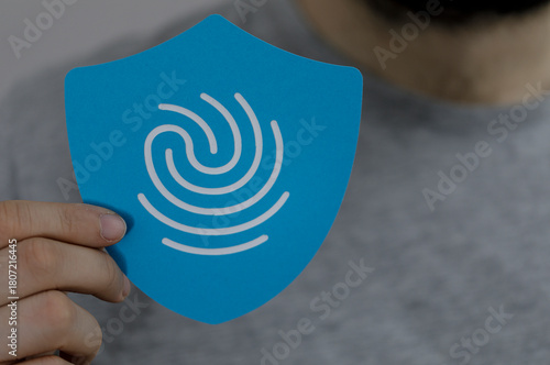 A person holds a blue shiel...