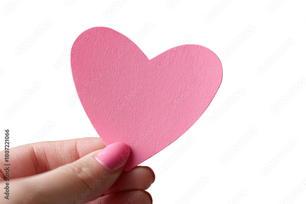 Fototapeta premium A pink heart-shaped cutout held by a hand