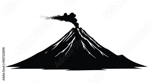 Dramatic silhouette of an active volcano erupting with smoke billowing from its peak.