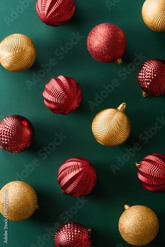 Christmas decoration ornaments on green background viewed from above. Top view