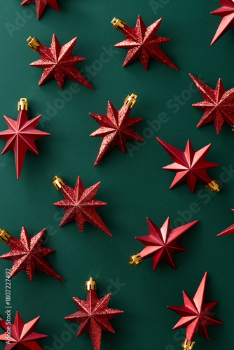 Christmas decoration stars on green background viewed from above. Top view