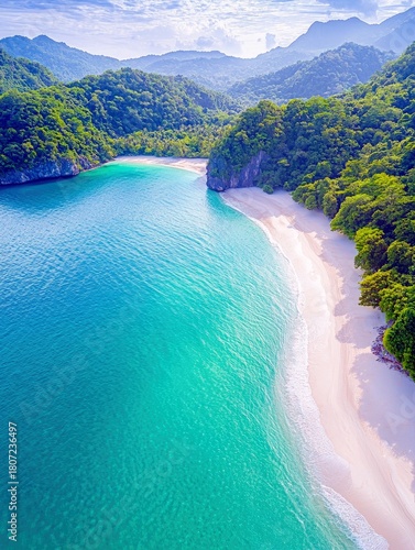 An aerial perspective captures a serene tropical bay where vibrant turquoise waters meet a pristine white sand beach, framed by verdant, tree-covered mountains.