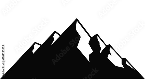 Dramatic silhouette of jagged mountain peaks against a clear sky, symbolizing adventure and achievement.