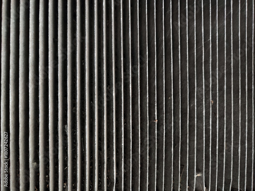 Dirty cabin air filter being replaced in a car.