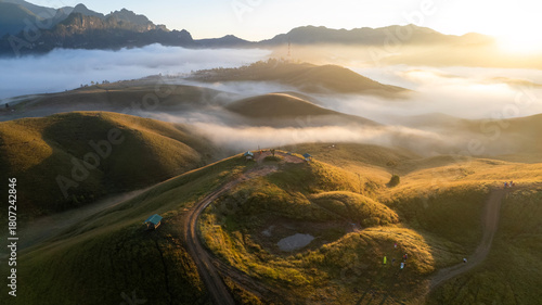 Fototapeta Naklejka Na Ścianę i Meble -  Aerial View landscape of bright sunrise over misty  golden meadow on morning. Phu Hua Lon, Xaysomboun, Laos.