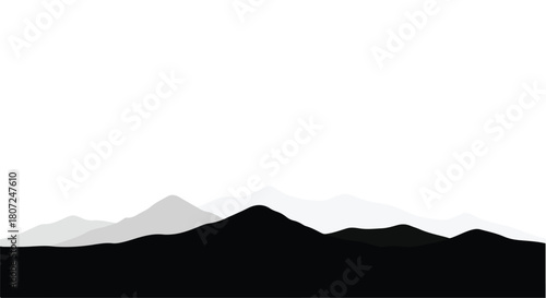 Serene mountain peaks in layered silhouette against a bright sky