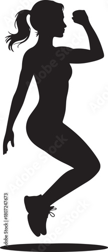 Silhouette of a woman jumping with one arm raised in a fitness pose