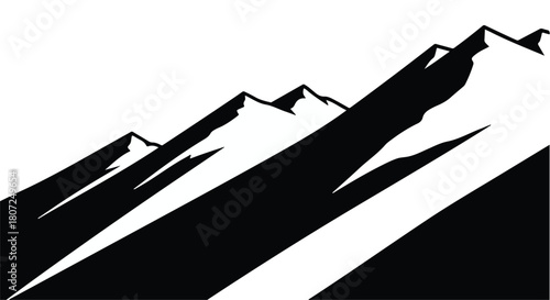 Dramatic black and white silhouette of jagged mountain peaks against a bright sky.