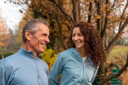 Senior couple sharing a happy moment outdoors, enjoying autumn park activity