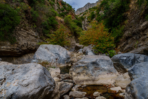 Boulder-filled gorge beneath steep limestone walls