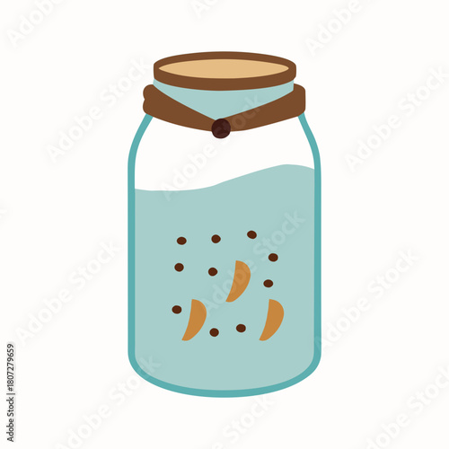 Glass jar filled with homemade cookies tied with rustic ribbon