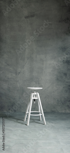 White stool on a A high-resolution textured gray studio backdrop with subtle gradients and painterly details. Ideal for portrait photography, product shoots, graphic design compositions