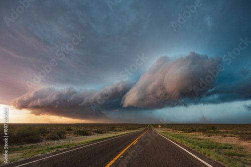 Tracking a Supercell alomg Texas Highway 285, grey cloud formations hovering over the land. 