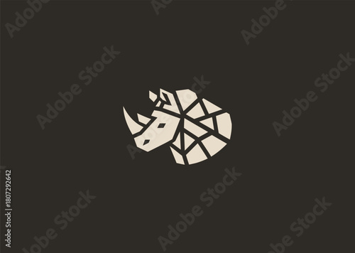 A strong geometric rhinoceros logo formed with sharp polygonal contours and structured line blocks, symbolizing power, protection, and resilience in a clean minimalist vector style