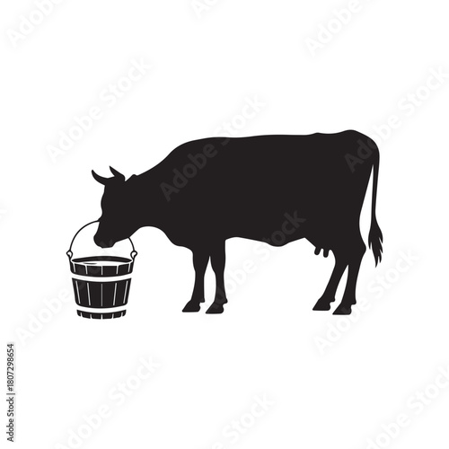 Cow silhouette drinking from a wooden bucket