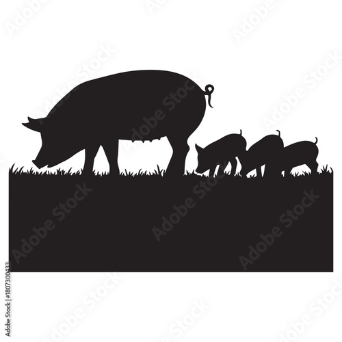 Mother pig and piglets grazing in grass