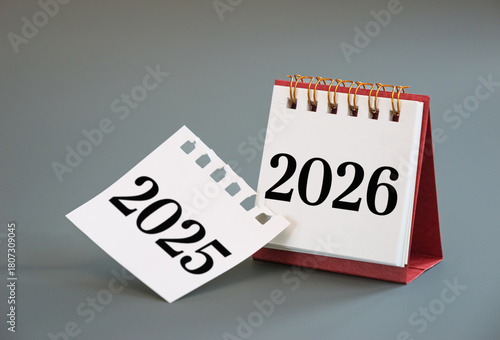 turning calendar page from 2025 to 2026, New Year calendar concept. desk calendar flip page for new year celebration