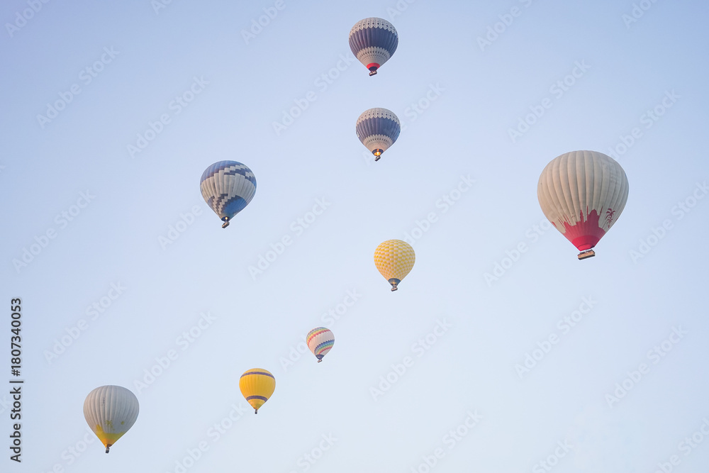 Fototapeta premium Hot Air Balloons over Cappadocia Valleys in Nevsehir, Turkiye