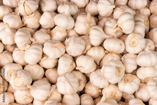 Fresh white garlic cloves displayed at a vibrant Kenyan market stall, highlighting healthy farm-fresh produce and natural cooking ingredients