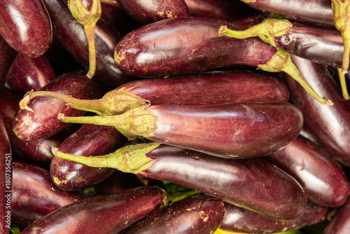 Fresh purple eggplants displayed at a vibrant Kenyan market stall, highlighting nutritious tropical produce and healthy farm-to-market vegetables