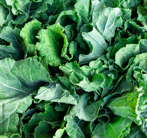Fresh green kales (sukumawiki) displayed at a vibrant Kenyan market stall, highlighting nutritious farm-fresh vegetables and healthy eating