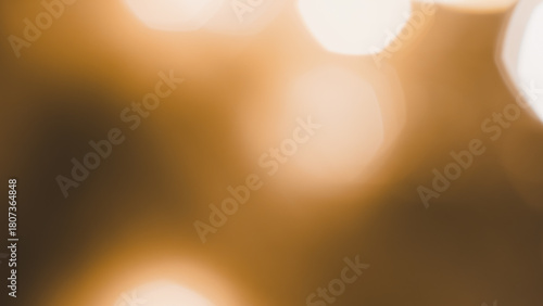 Fotografie Soft brown and golden bokeh lights creating warm festive holiday atmosphere vibe