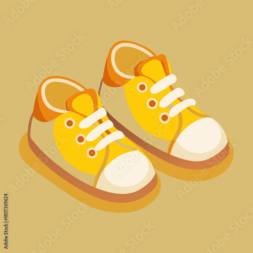 Pair of yellow baby sneakers with white laces isolated on beige background
