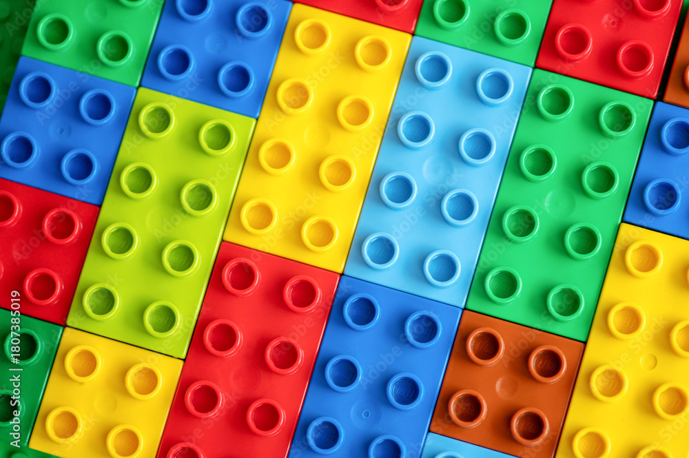 Naklejka premium Colorful plastic building blocks background. Top view. 