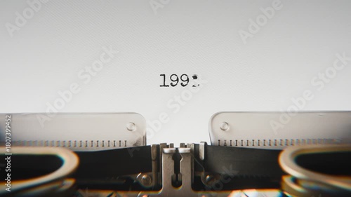 Old mechanical typewriter typing Year 1992 in a close-up view, with metal letters striking the white paper.