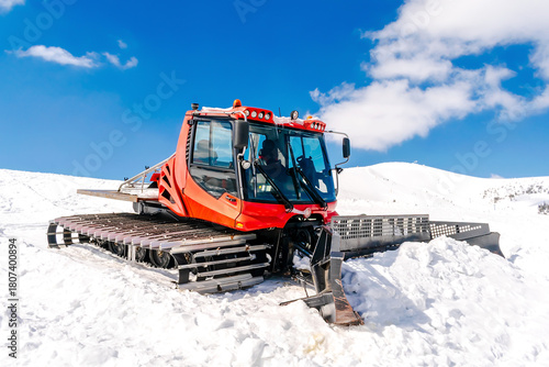 Photos Snowcat ratrack with snowplow,snow grooming machine,remover truck preparing ski slope,piste,hill at alpine skiing winter resort